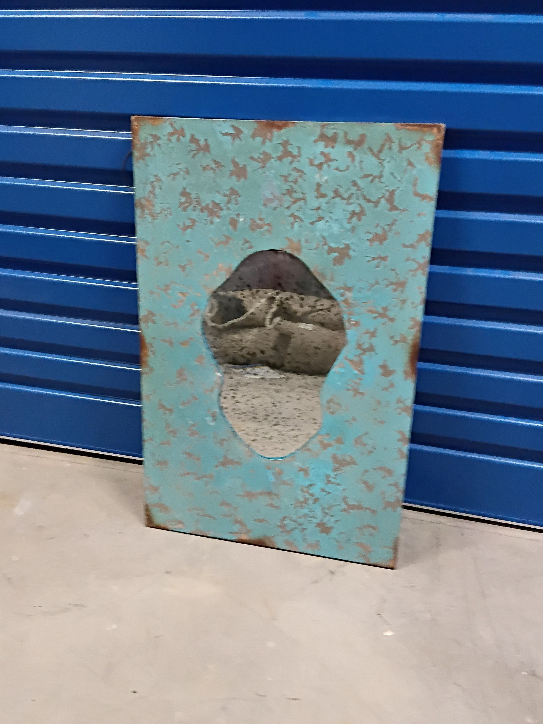 A RUSTIC WALL MIRROR