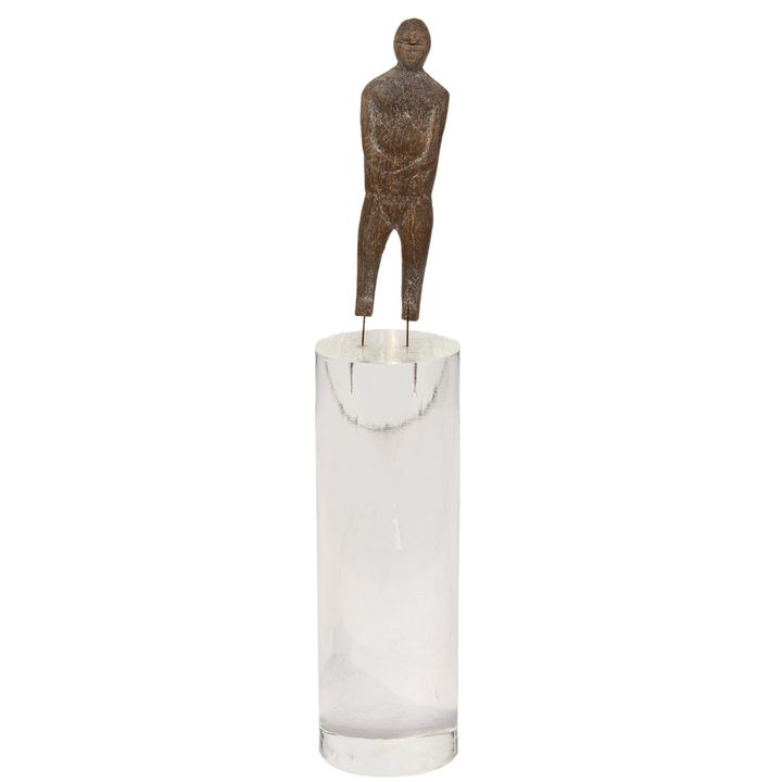 An Inuit carved wood 'doll' in the form of a nude male clasping his arms