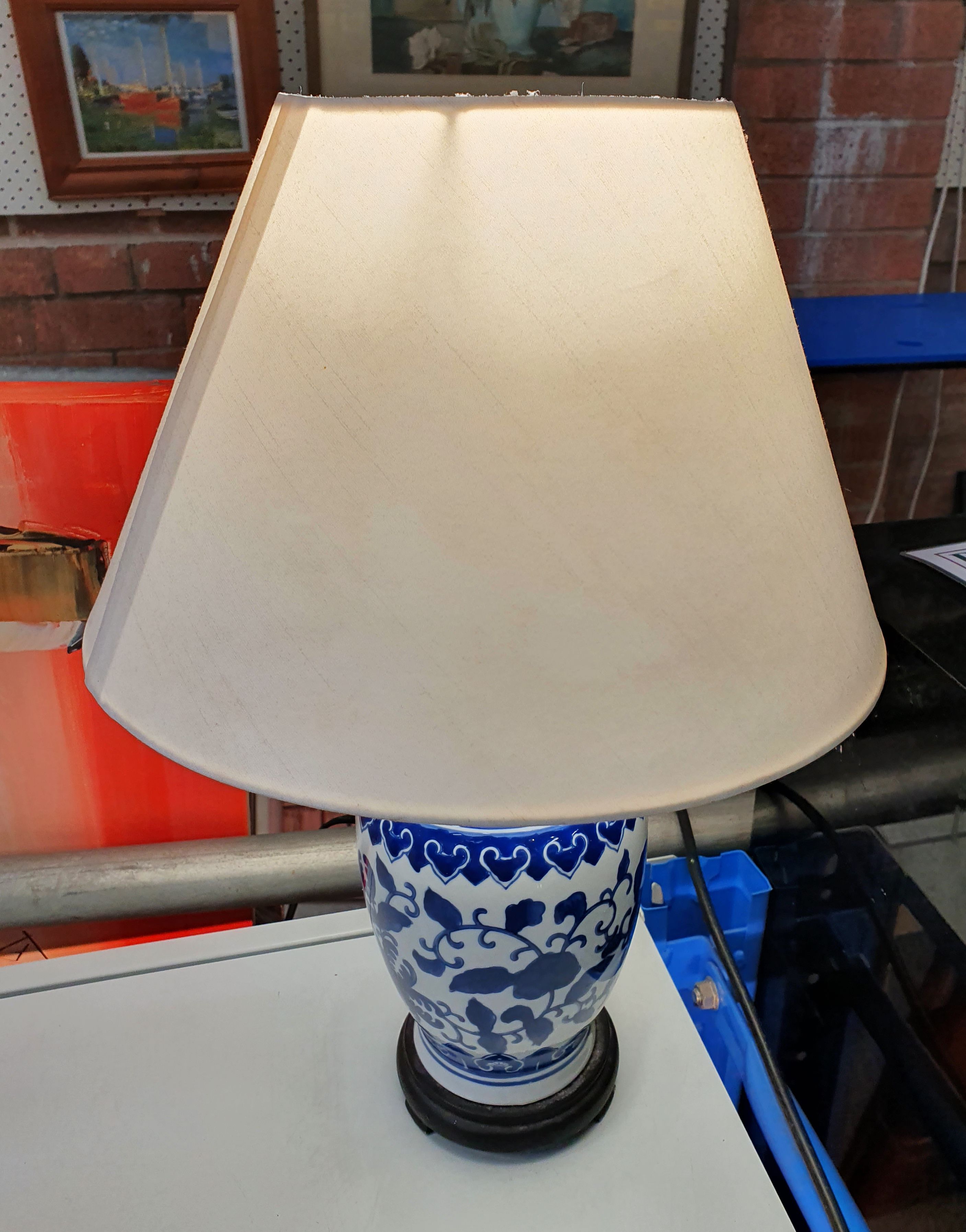 A Blue And White Table Base With A Shade