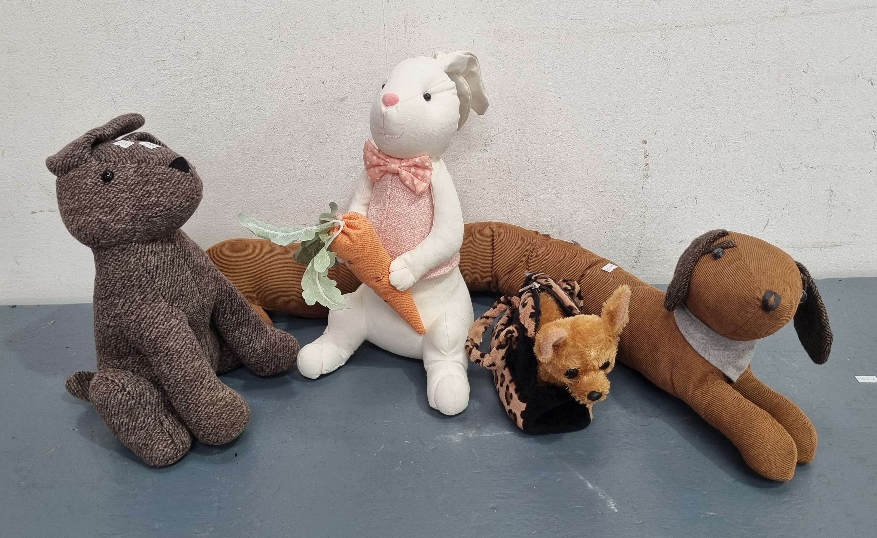 A Group Of Stuffed Animal Doorstops