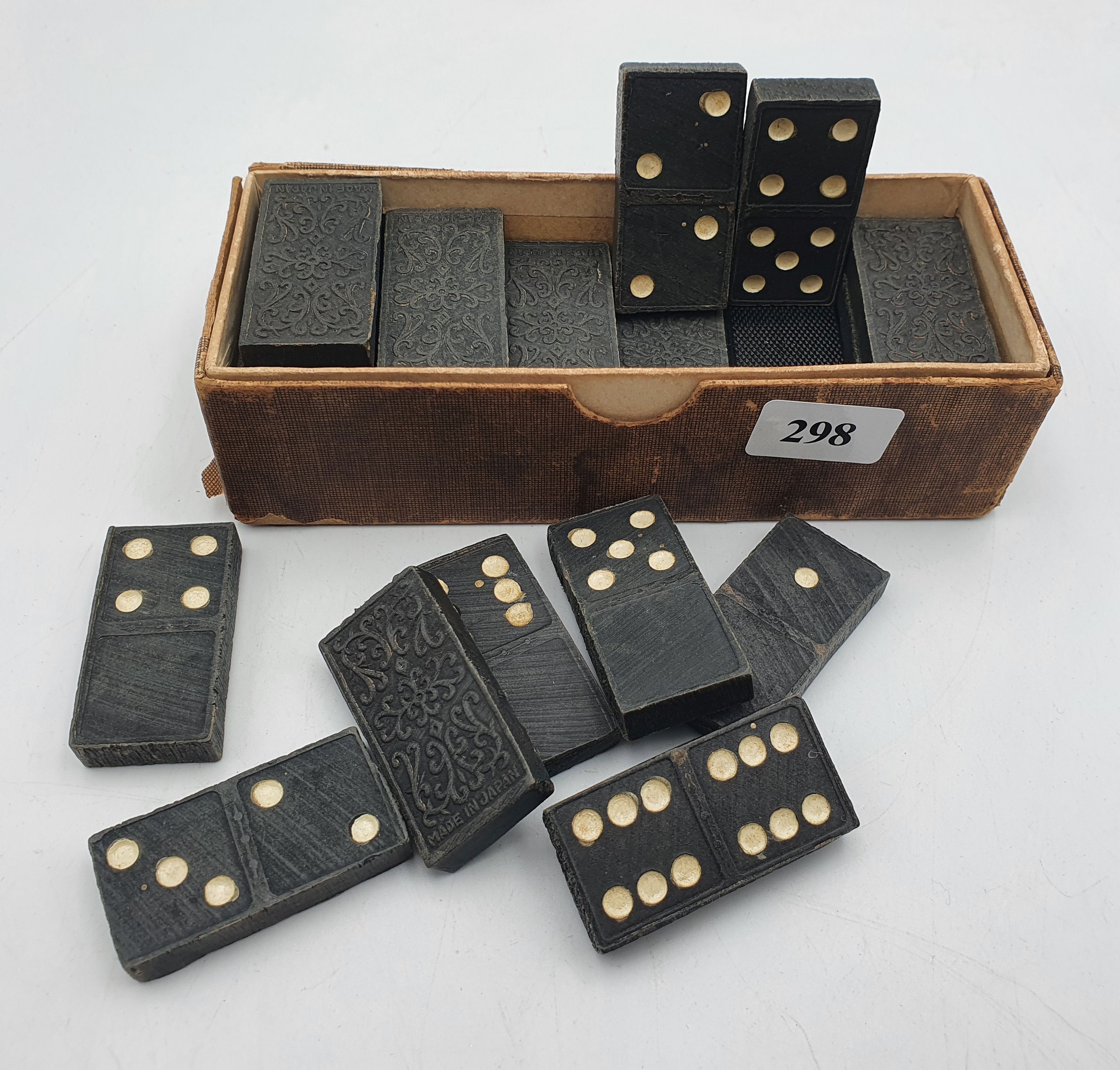 298 · AN EARLY JAPANESE EBONY CARVED SET OF DOMINOES