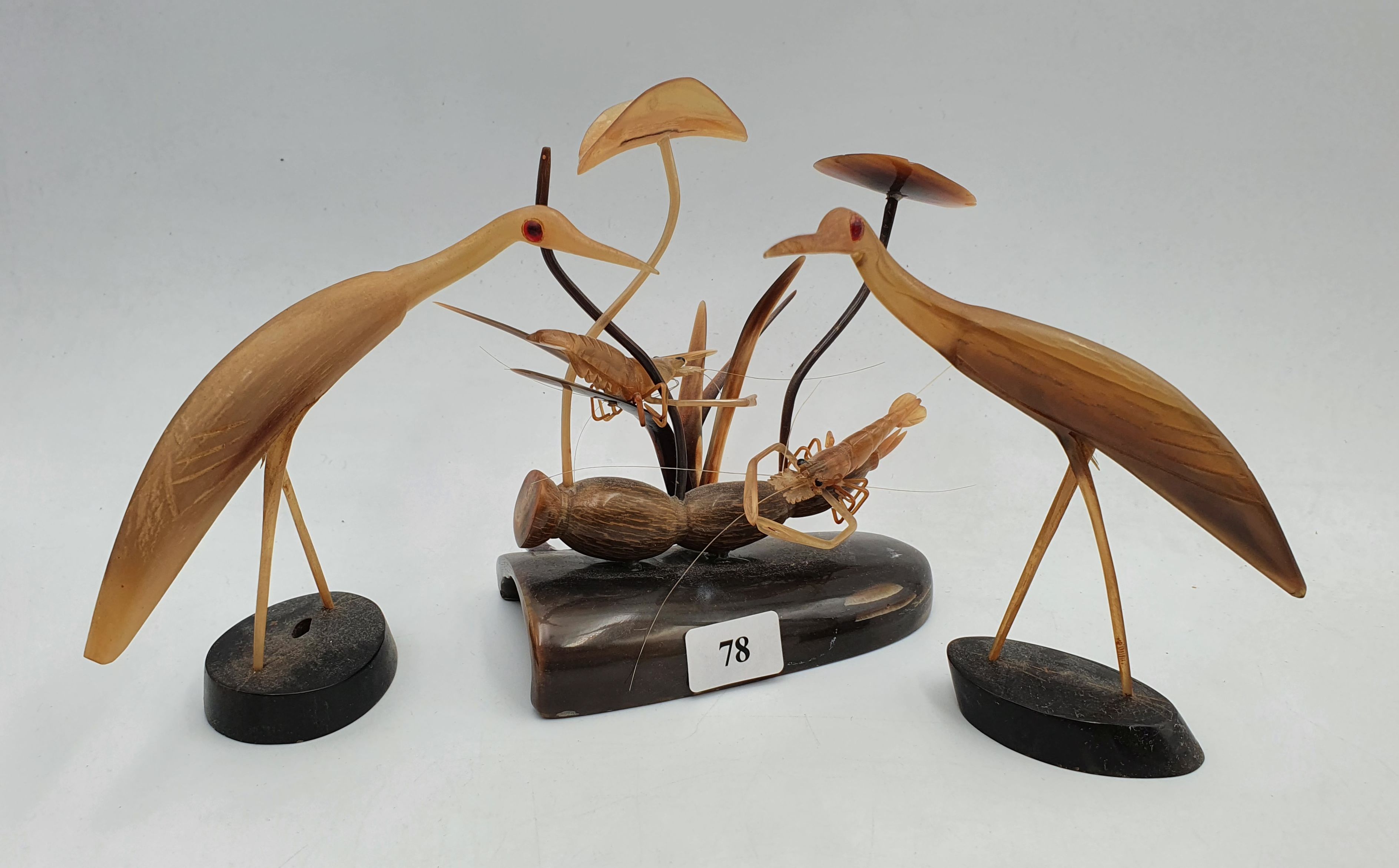 78 · A GROUP OF CARVED HORN FIGURES