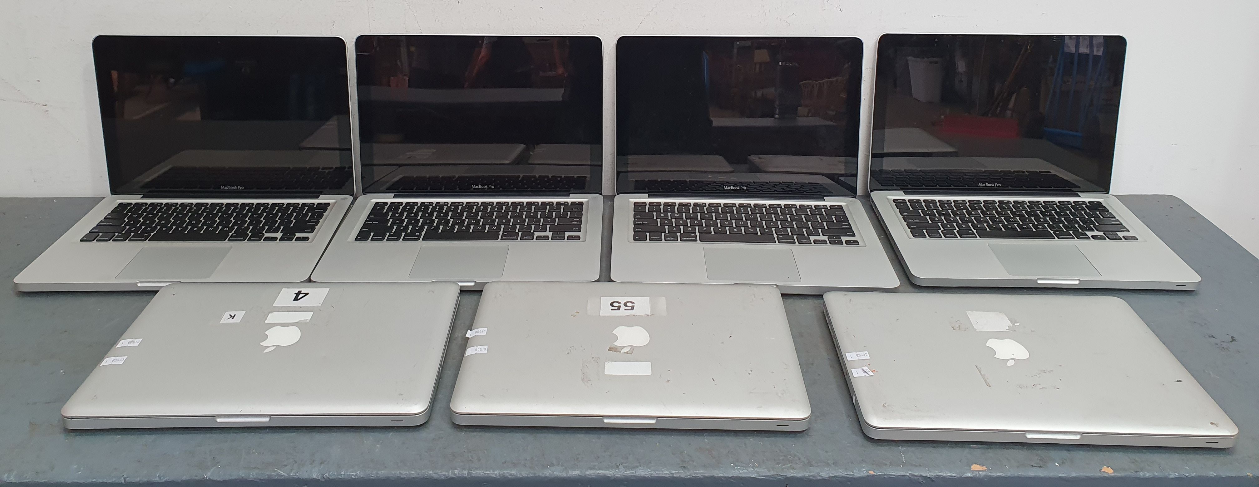 A GROUP OF SEVEN APPLE LAPTOPS