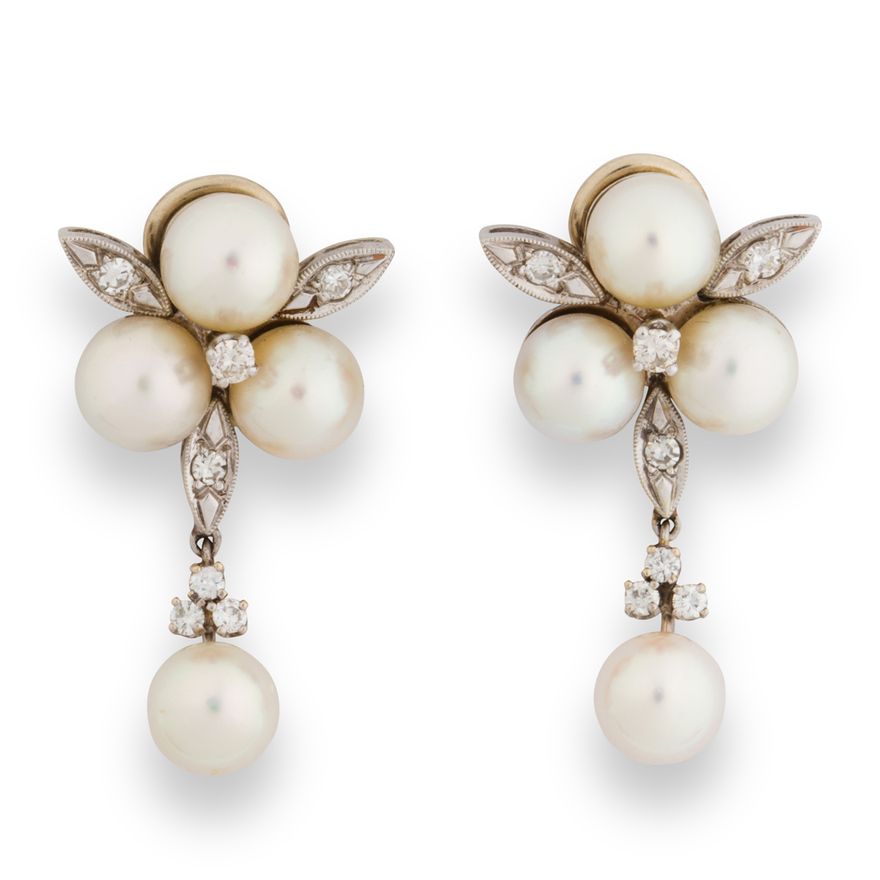 A pair of pearl, diamond and fourteen karat white gold ear clips