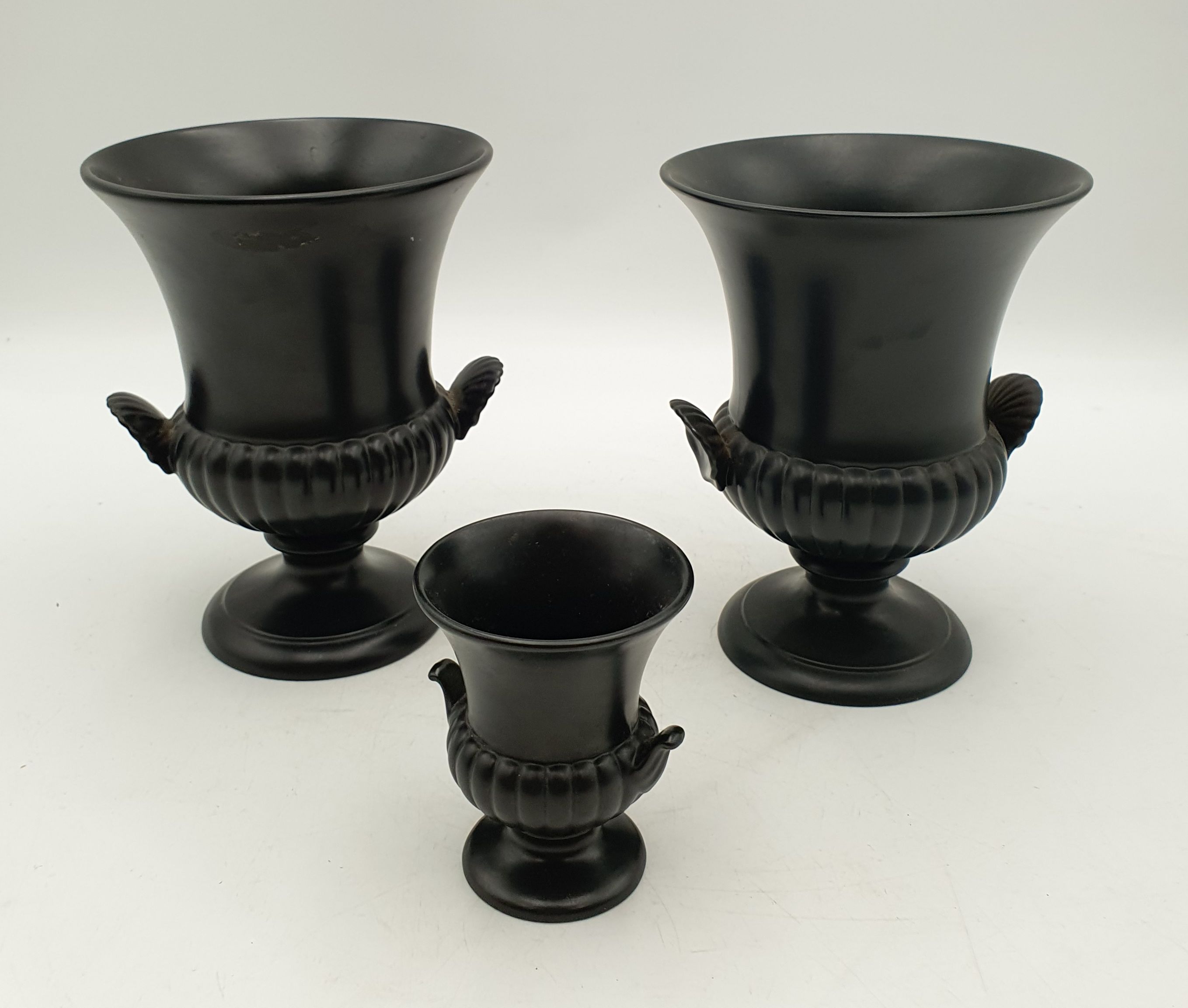 A PAIR OF WEDGWOOD BLACK CAMPAGNA URNS