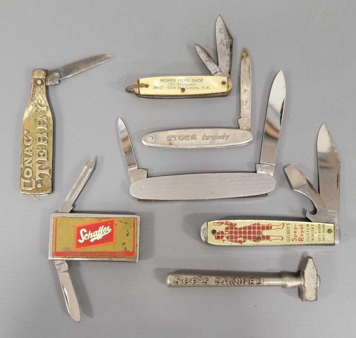Group of six old advertising pocket knives and a tiny sledge
