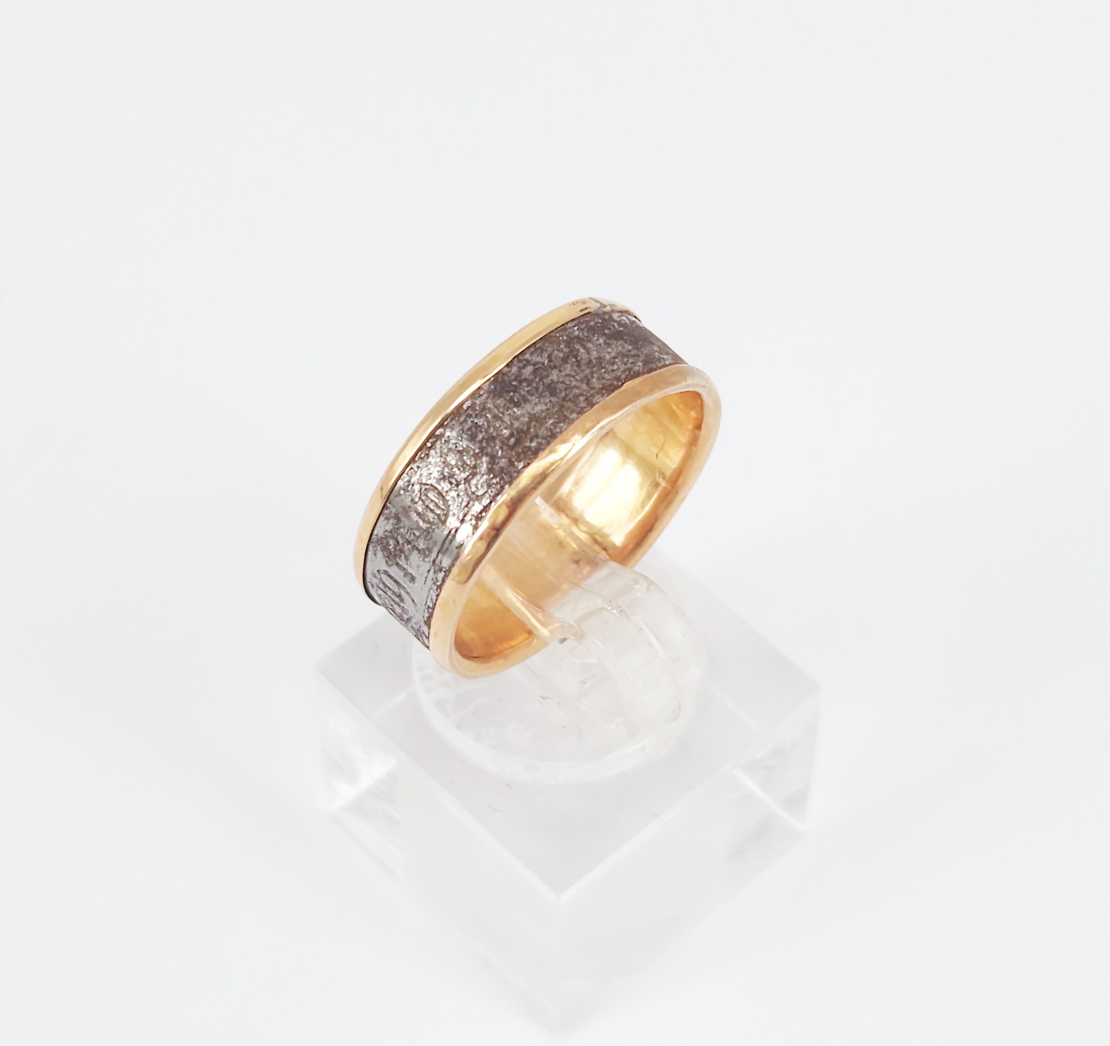A Silver And Rose Gold Band Ring