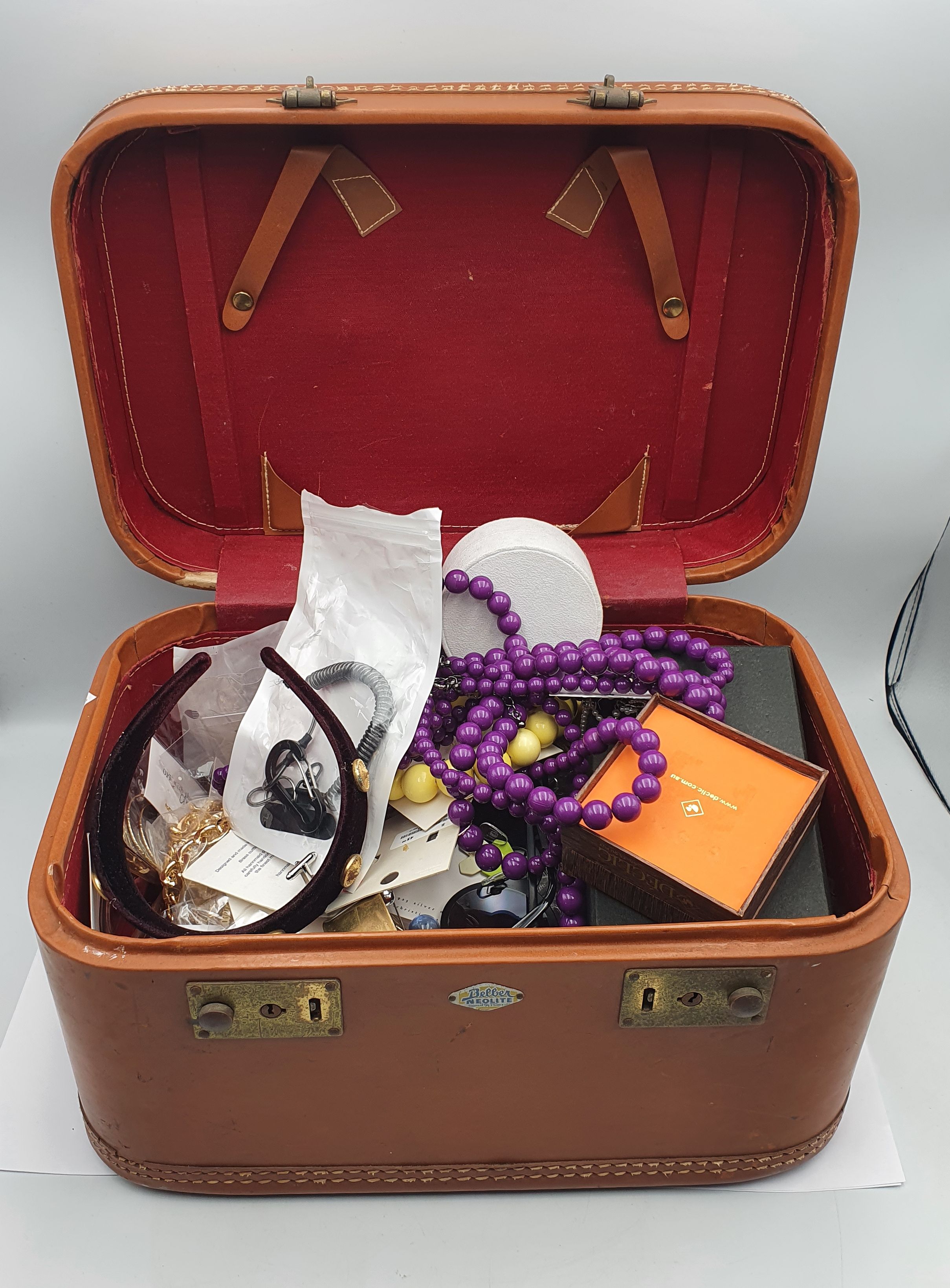 A LEATHER CASE OF COSTUME JEWELLERY