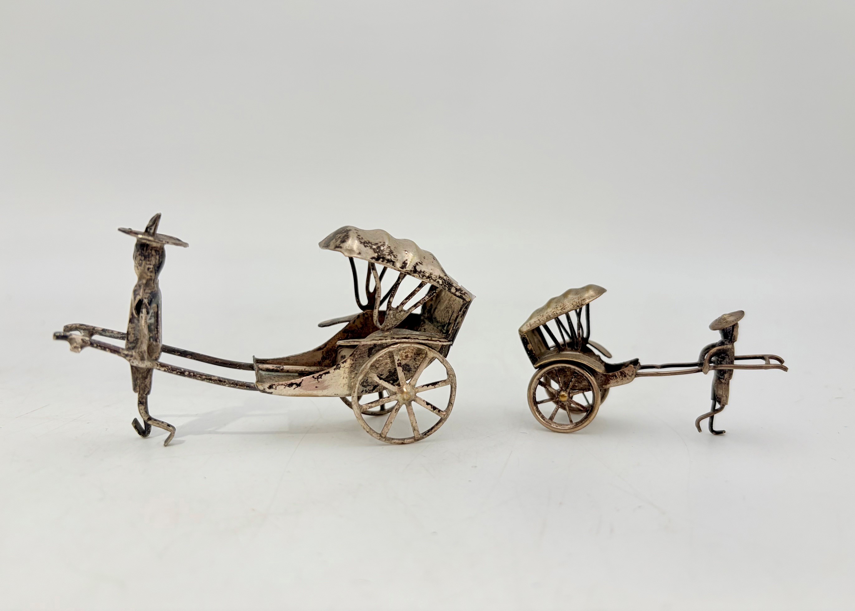 TWO CHINESE SILVER WHITE METAL MINIATURE RICKSHAW AND DRIVER ORNAMENTS