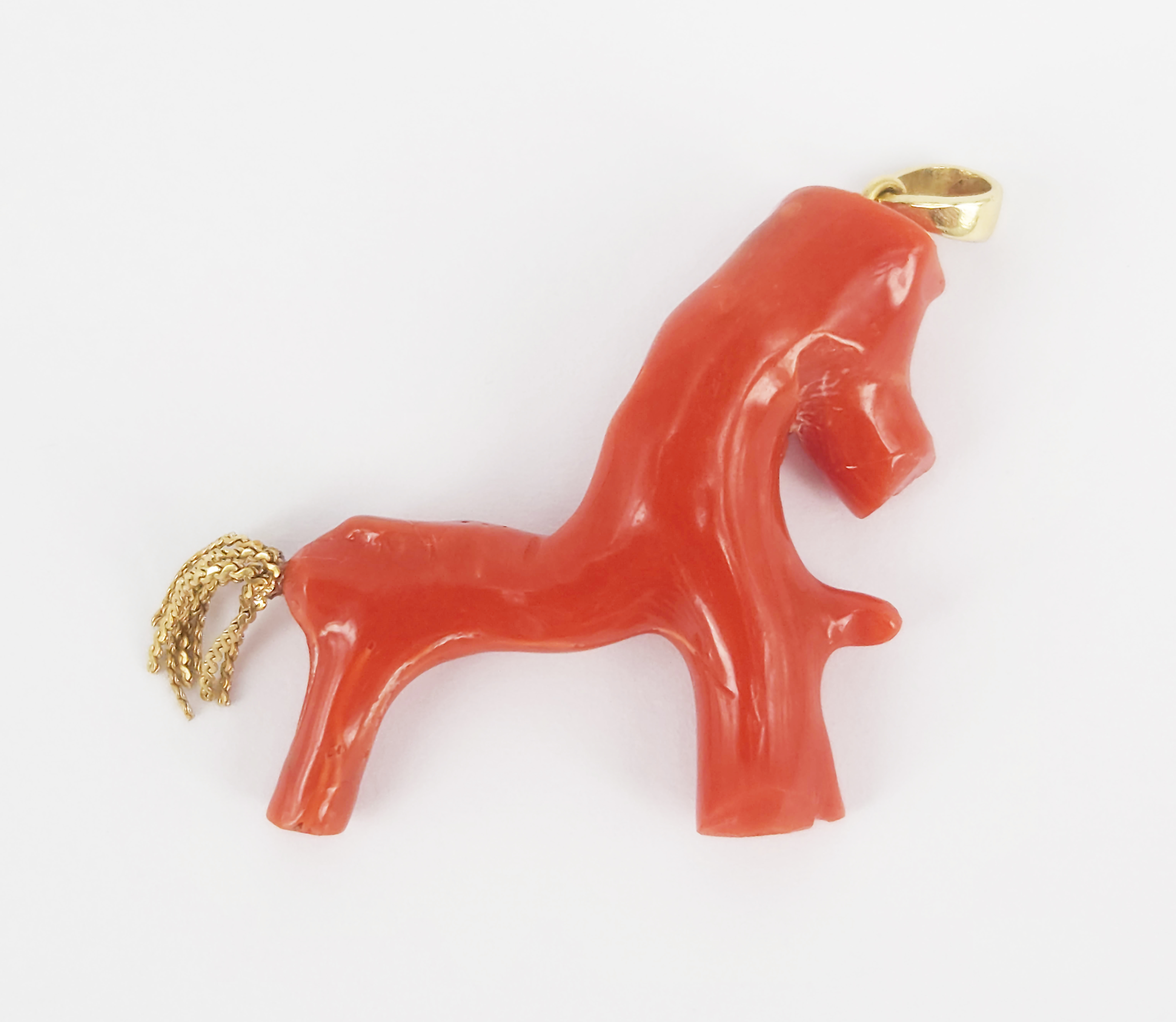 96 · A MEDITERRANEAN RED CORAL 'HORSE' PENDANT