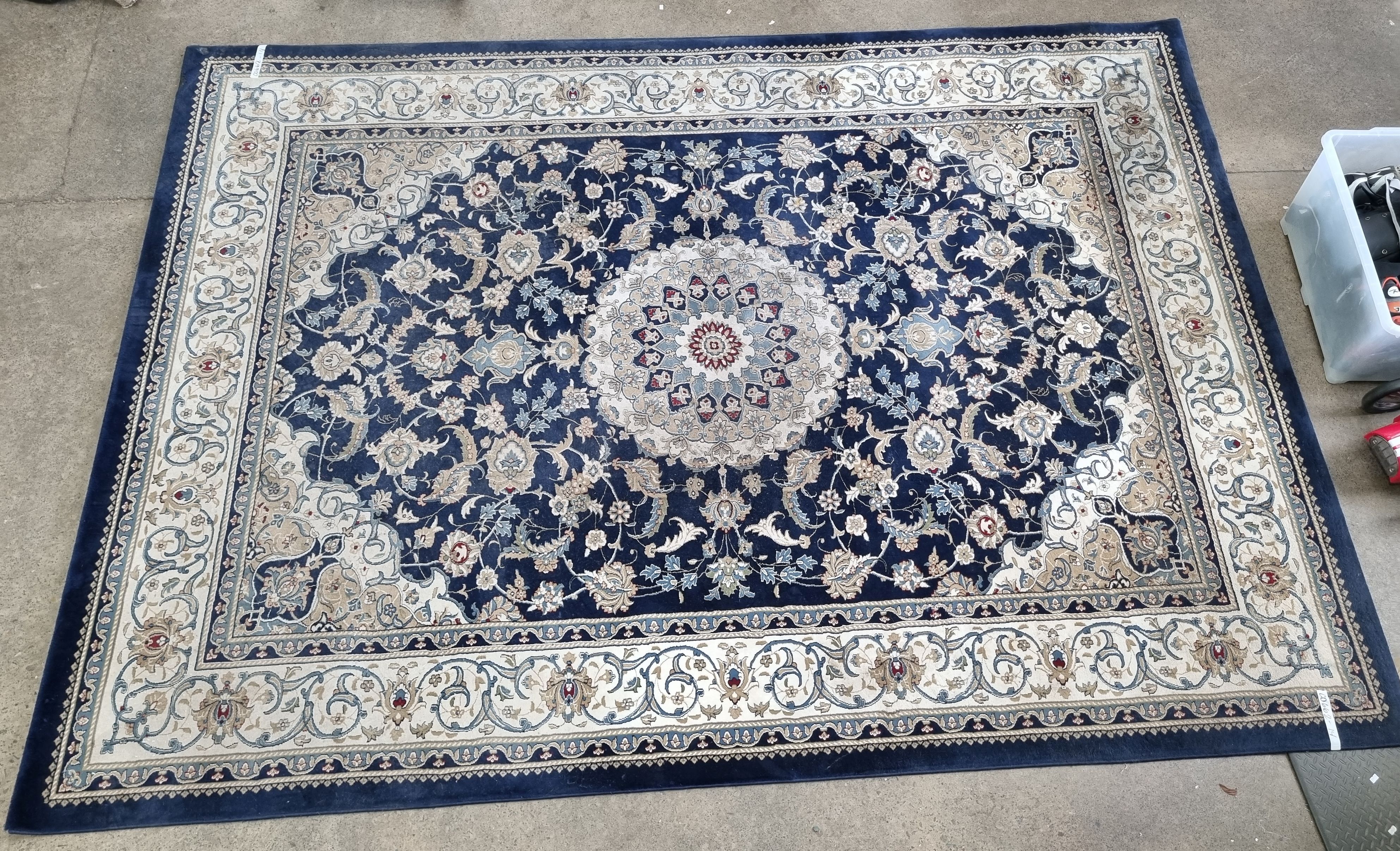 2125 · A MACHINE MADE RUG ON BLUE FIELD