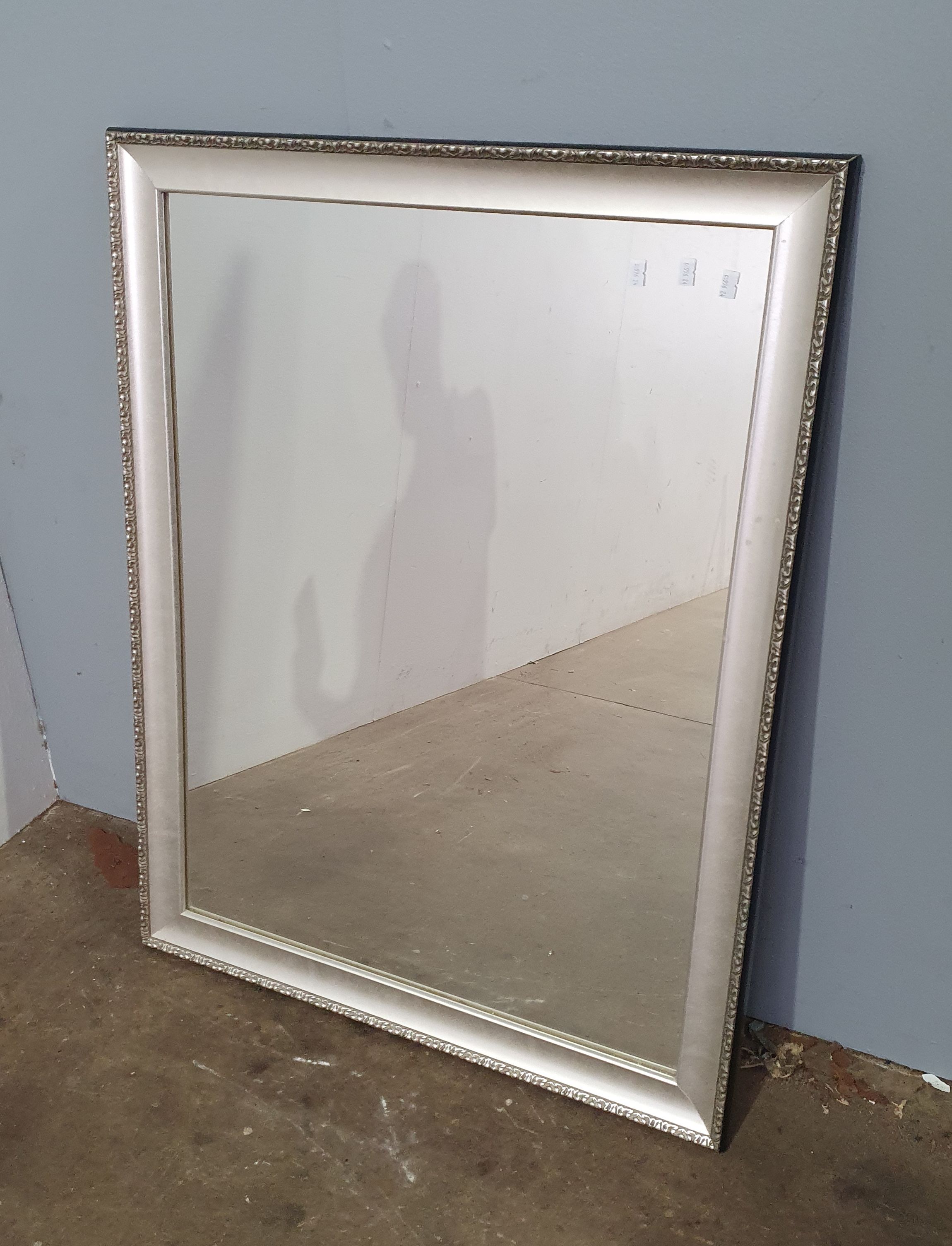 A SILVER FRAMED MIRROR