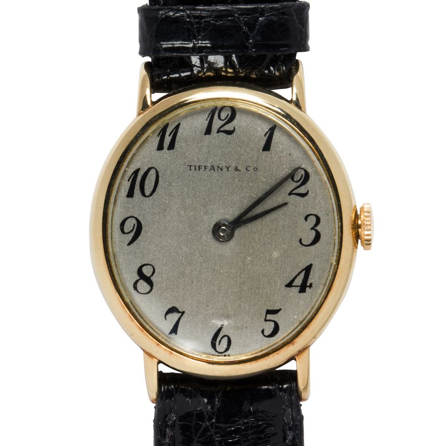 A Tiffany & Co. 14k gold and leather strap watch