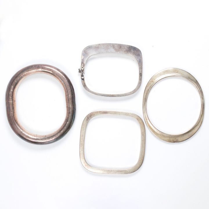 A group of silver bangles; including Tiffany & Co,