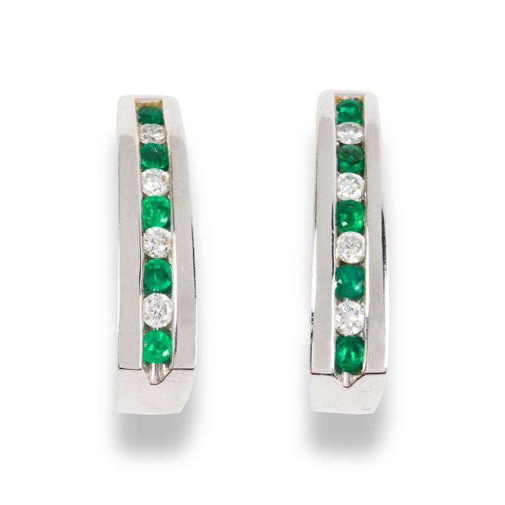A pair of emerald, diamond and eighteen karat white gold earrings