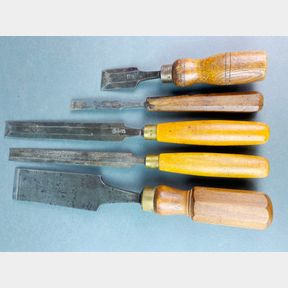 A group of 5 flat bottomed chisels with the longest being 38.5cm.