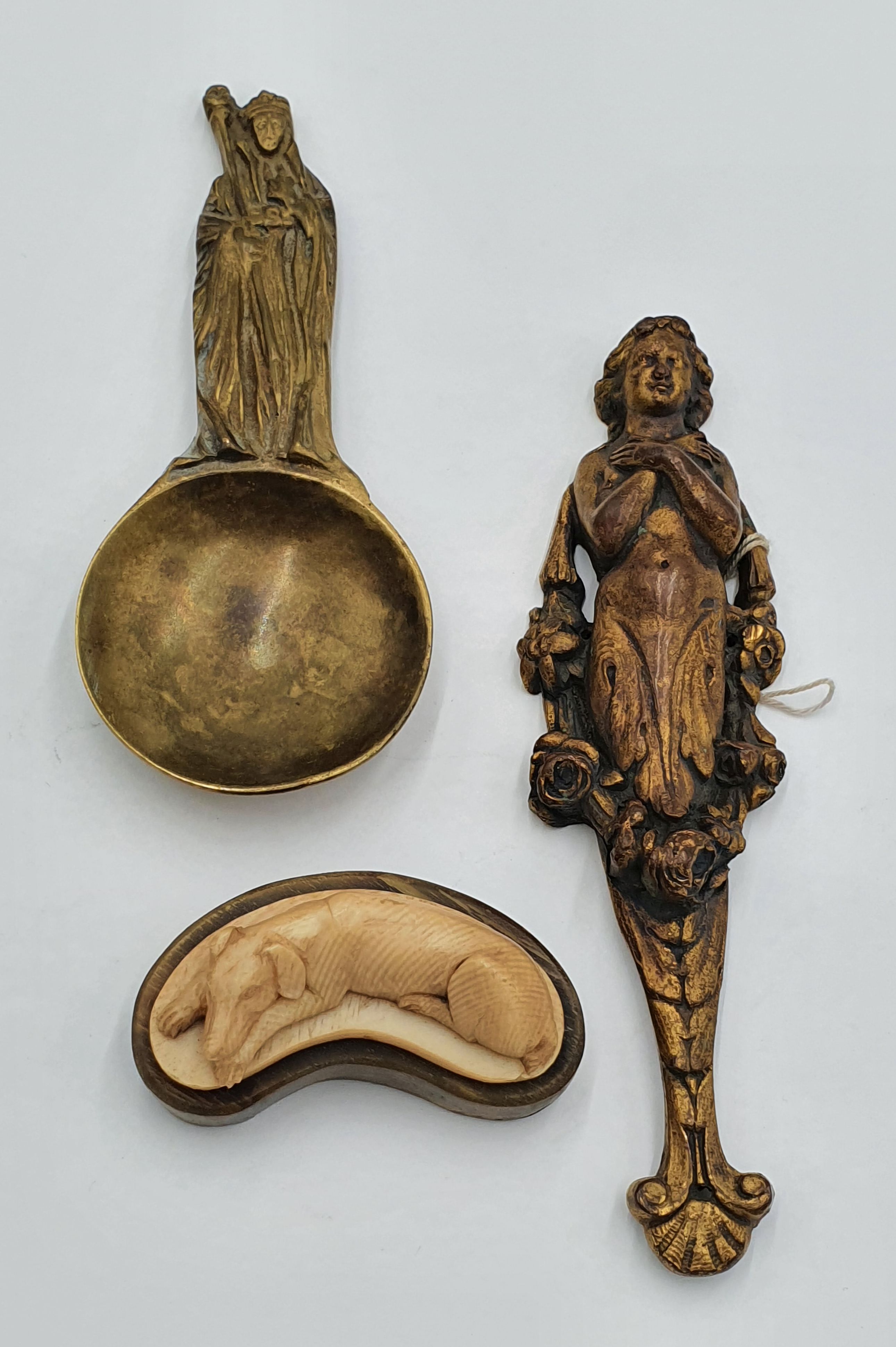 A Carved Ivory Figure Of A Recumbent Dog