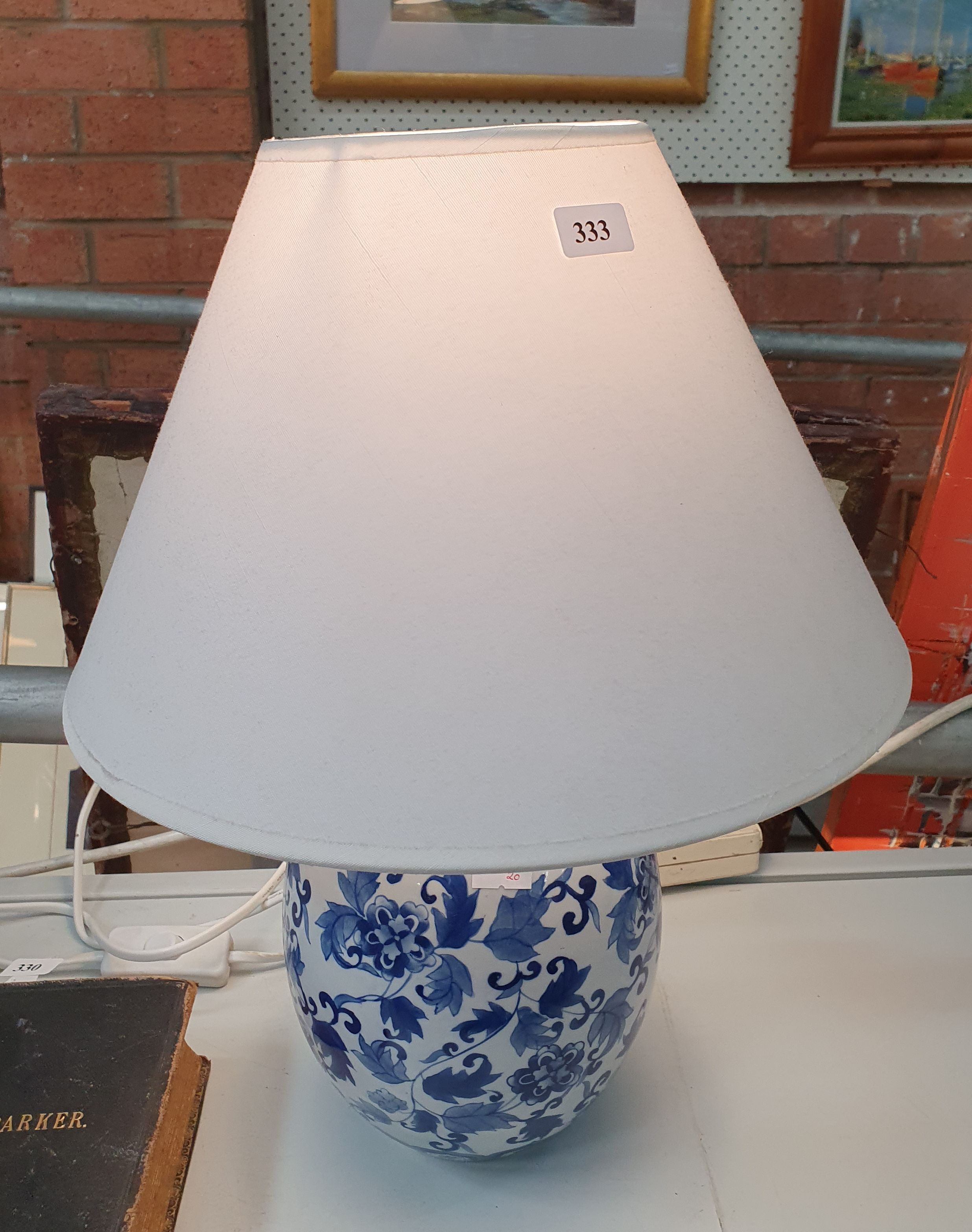 333 · A BLUE AND WHITE TABLE LAMP WITH SHADE