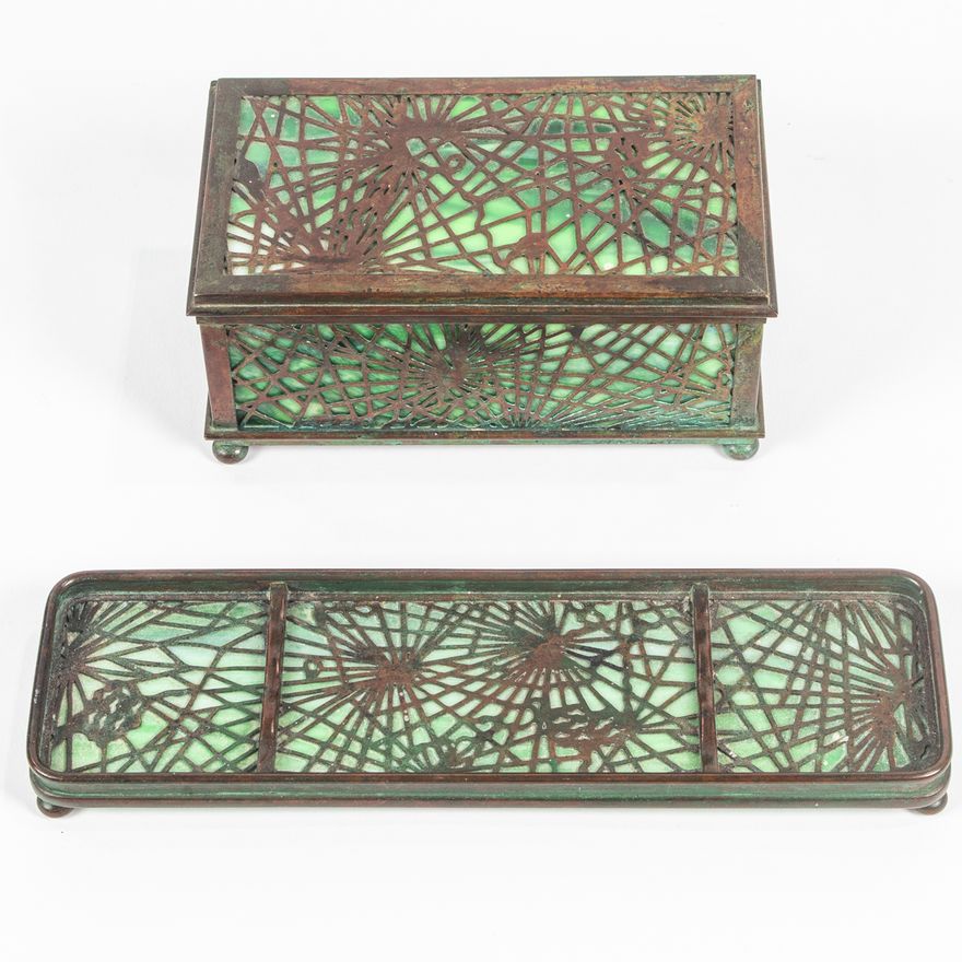 A Tiffany Studios patinated bronze and slag glass Pine Needle stamp box and pen tray