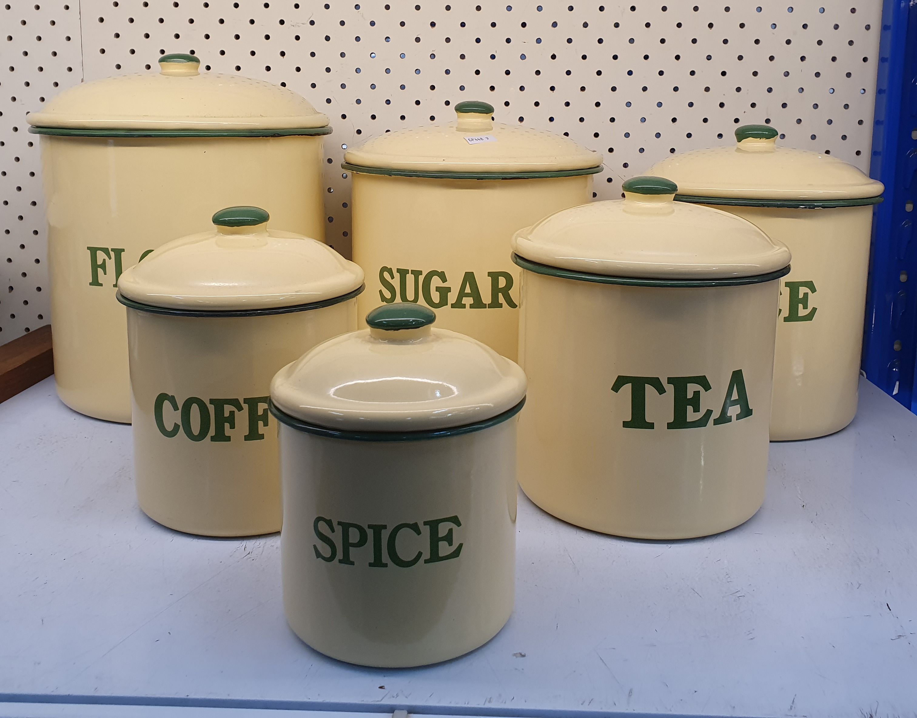 96 · A GRADUATING SET OF ENAMELLED FOOD STORAGE CANISTERS