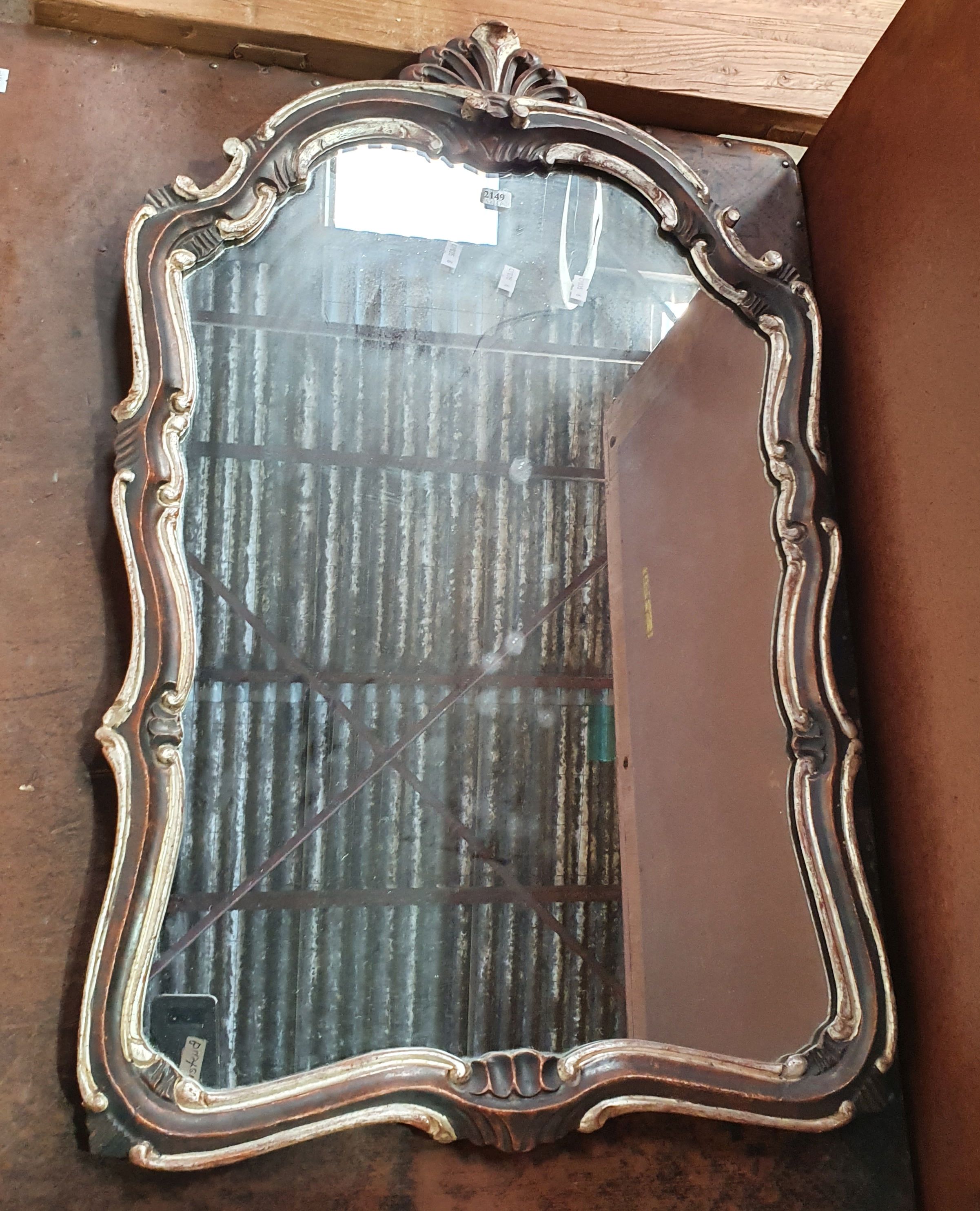 A SILVER FRAMED MIRROR