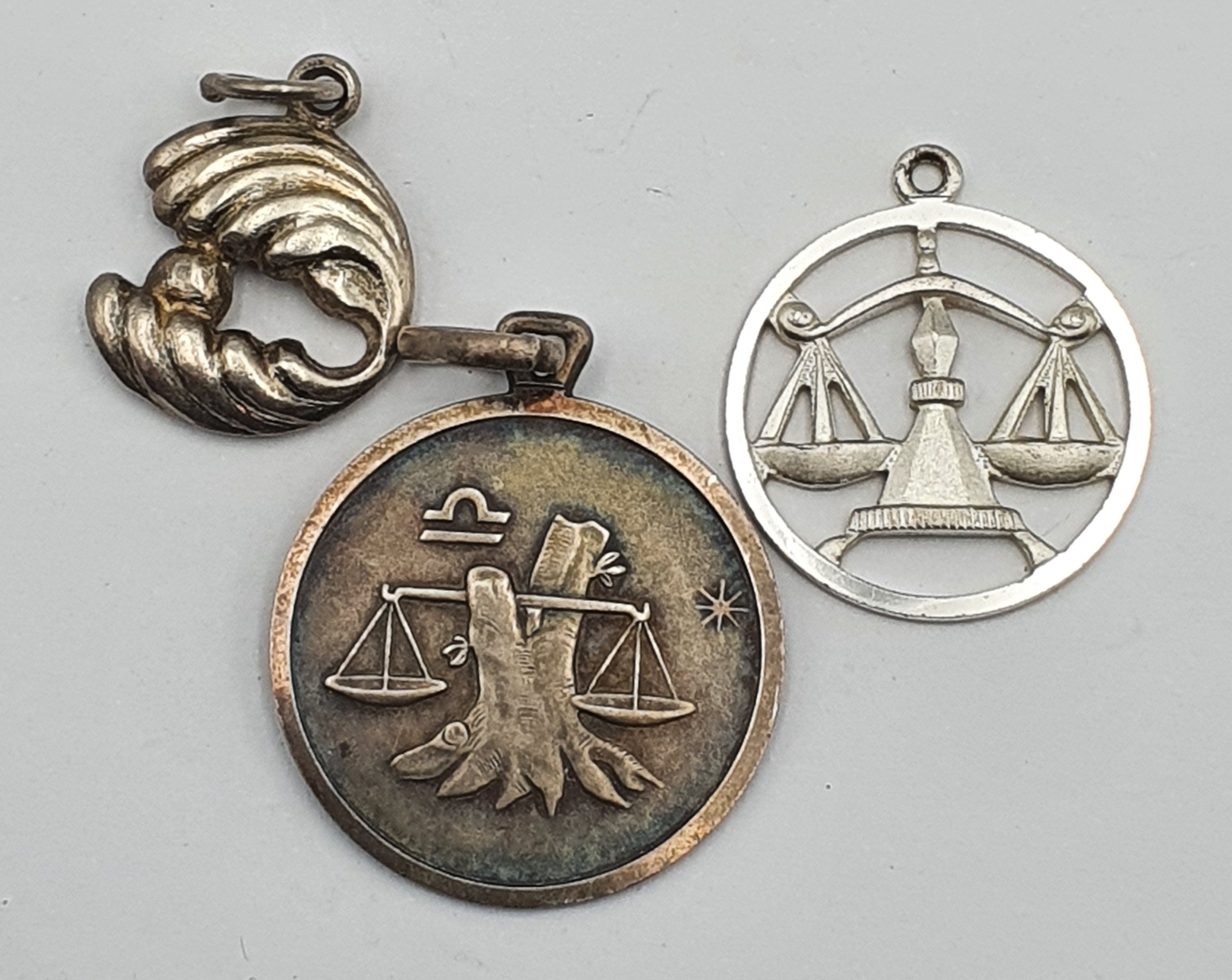 250 · THREE SILVER PENDANTS