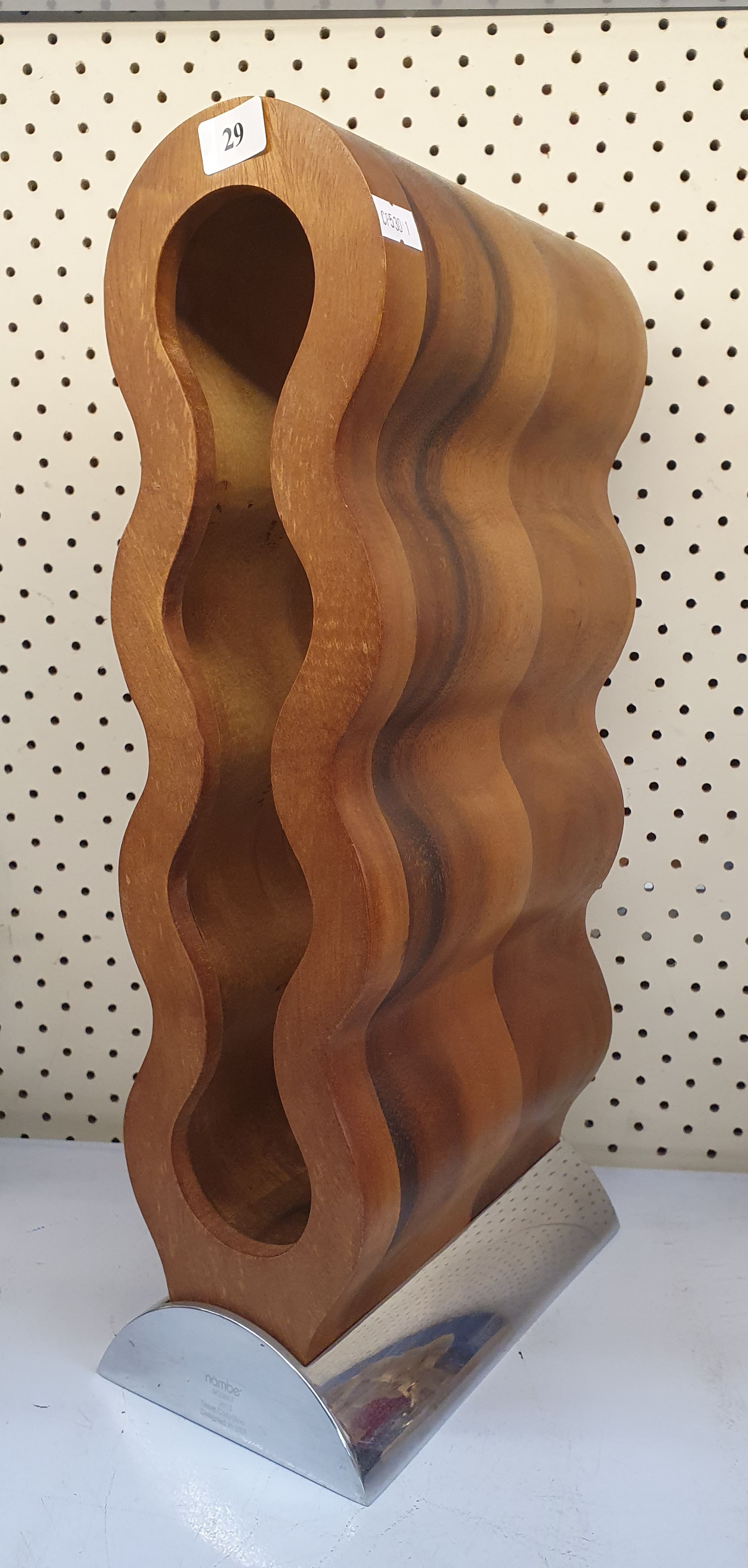A NAMBE CURVO WINE RACK DESIGNED BY STEVE COZZOLINO