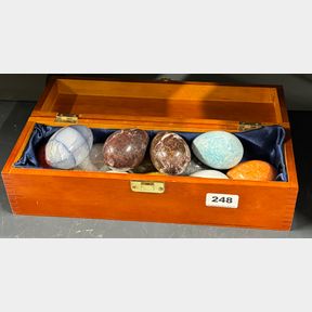 A box of large polished semi precious stone eggs, egg size 7cm.