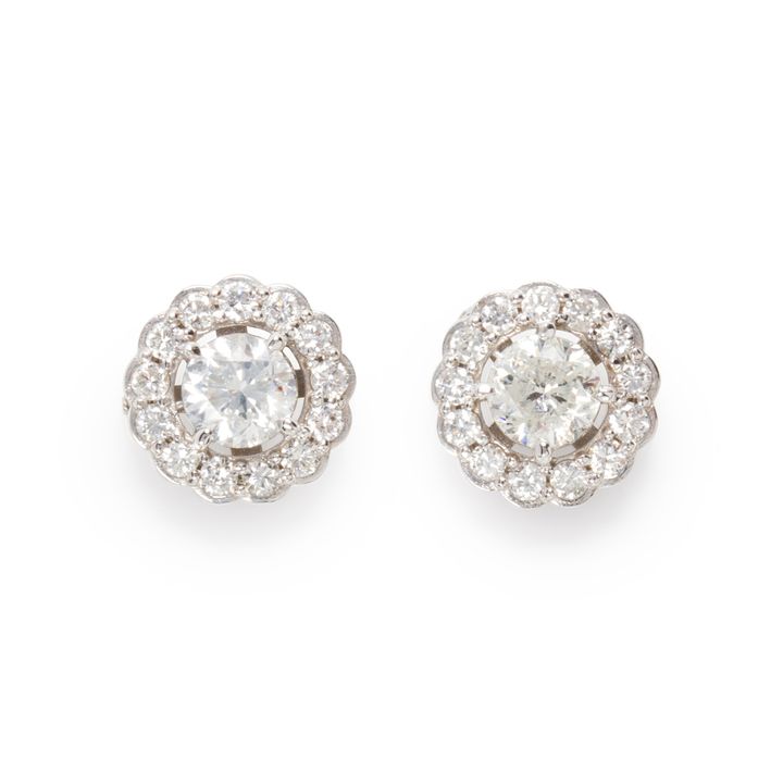 A pair of diamond and eighteen karat white gold stud earrings