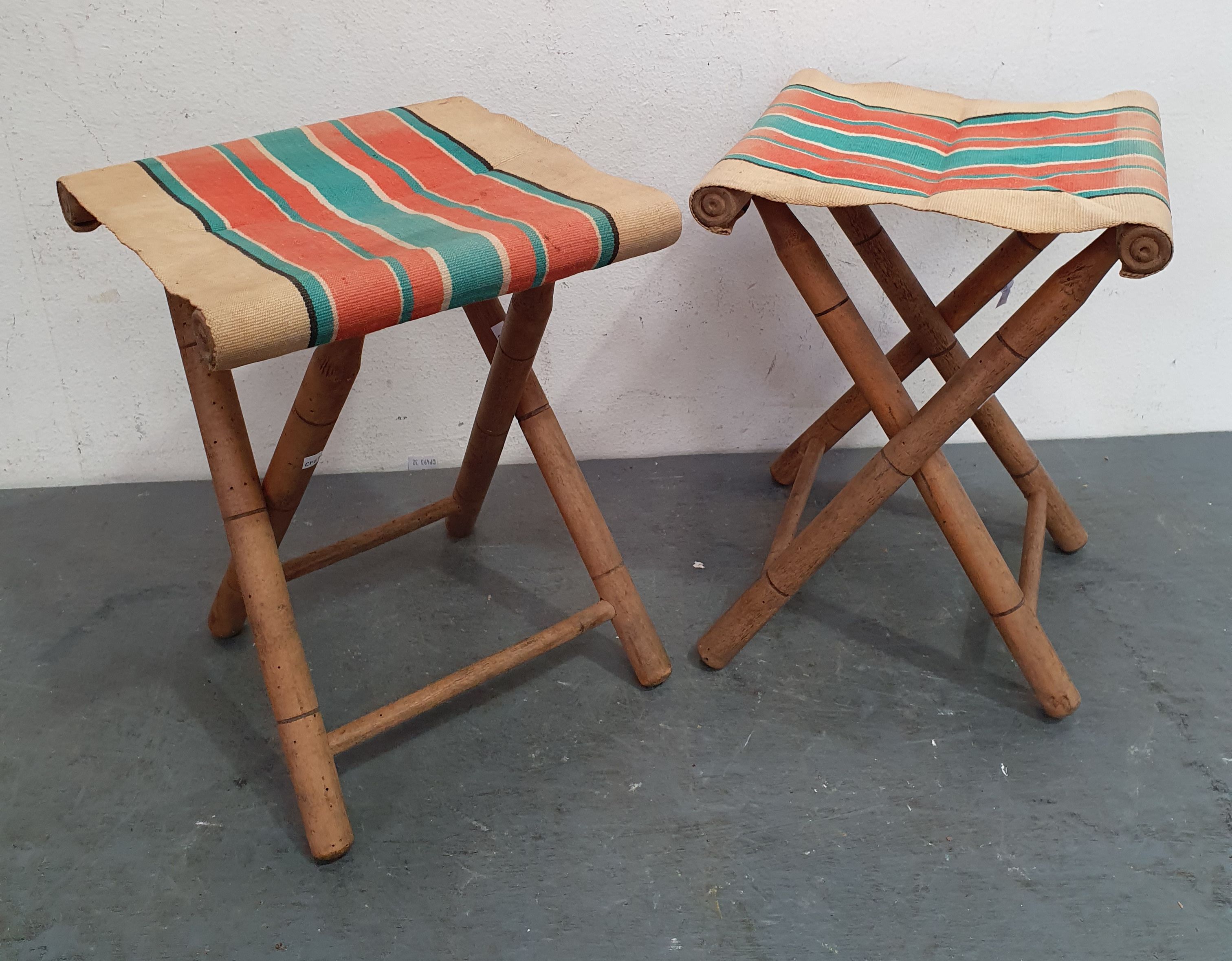 A PAIR OF VINTAGE FOLDING CANVAS STOOLS