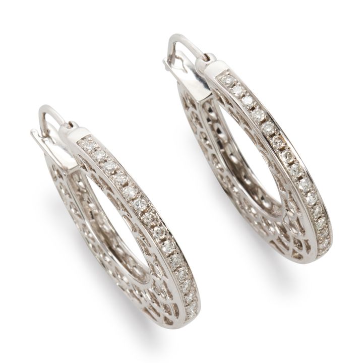 A pair of diamond and fourteen karat white gold earrings