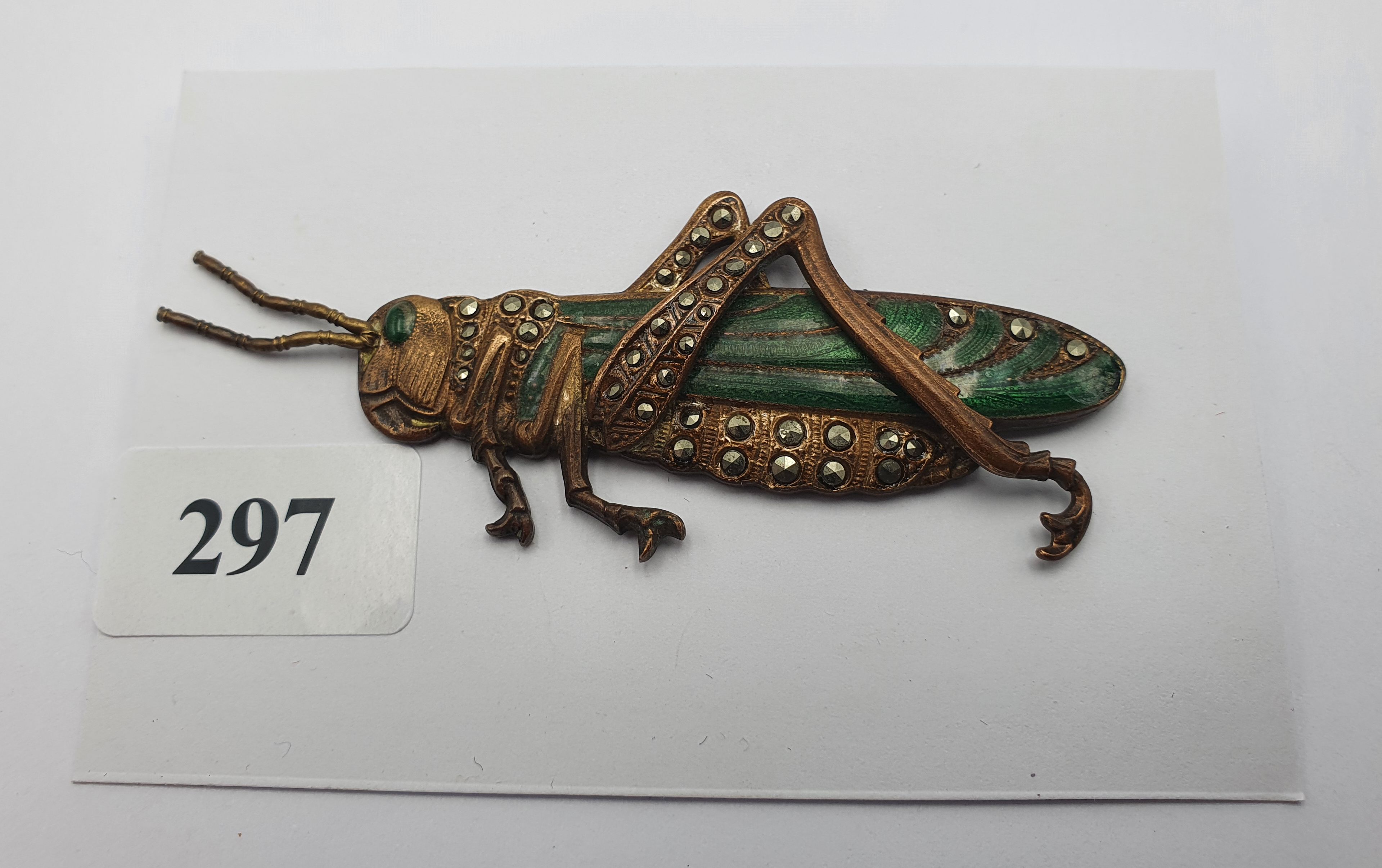 297 · A RARE VINTAGE BRONZE AND ENAMEL AND MARCASITE GRASSHOPPER BROOCH