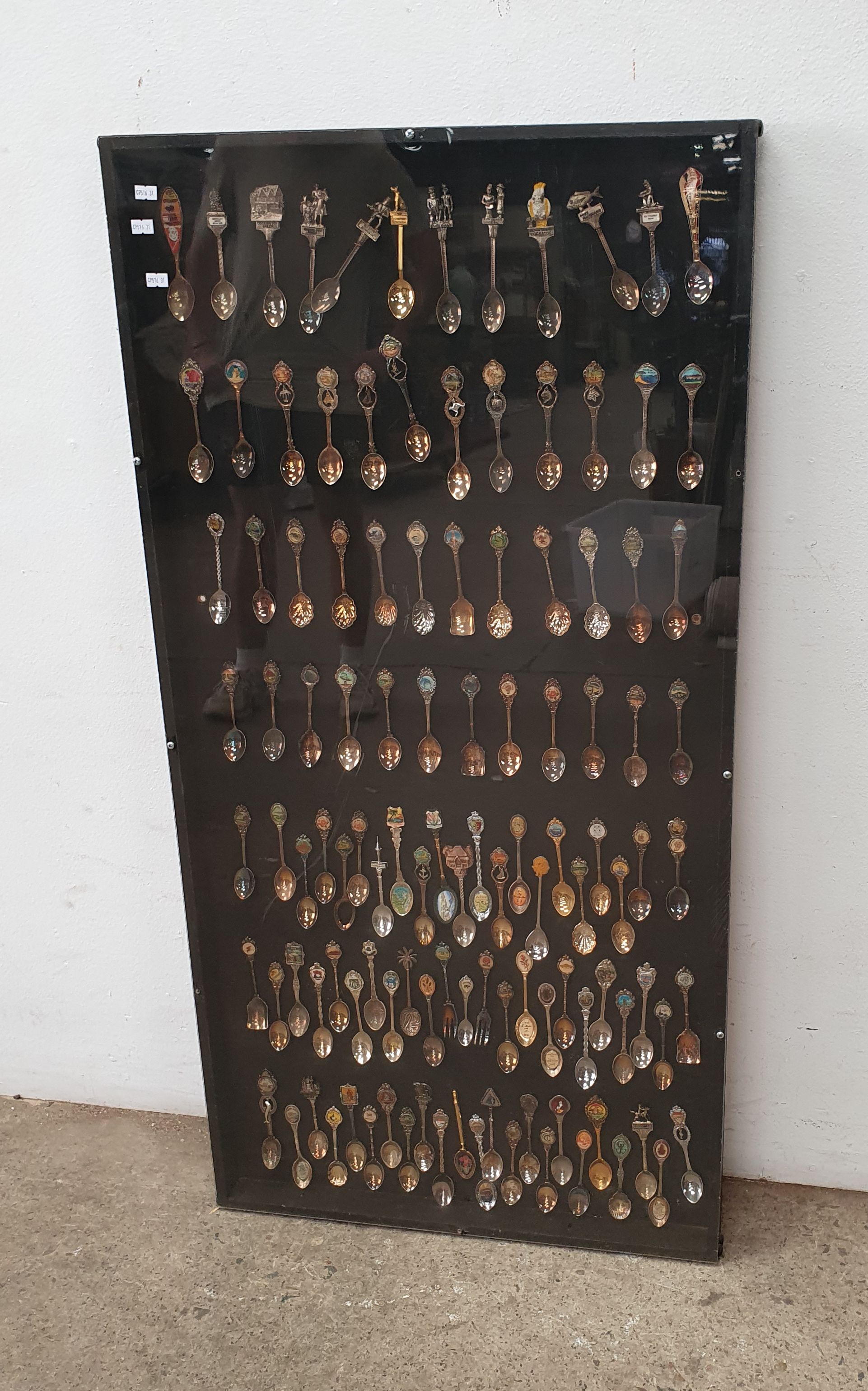 A LARGE DISPLAY OF COLLECTABLE SPOONS